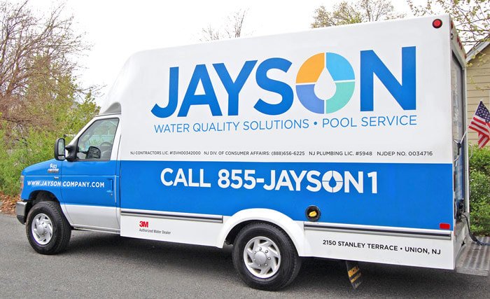 Photo of a new blue & white Jayson service truck featuring a large Jayson logo on the truck side