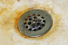 photo of tub drain with soap scum residue