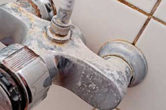 photo of heavy mineral scale build-up on tub faucet